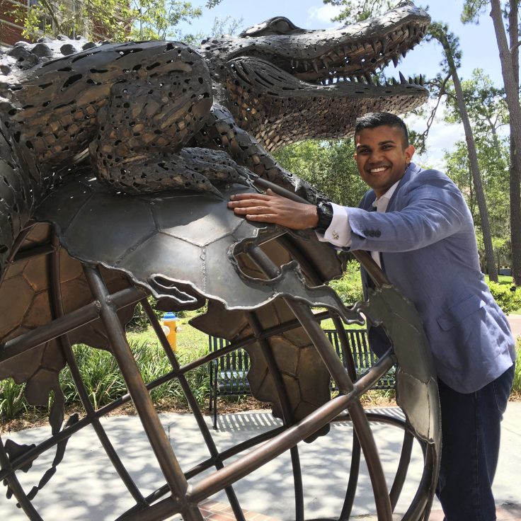 Portrait of Nirav Patel with the global gator statue