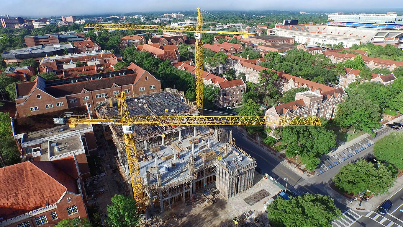 An aerial view of the new chemistry building and two large yellow cranes.