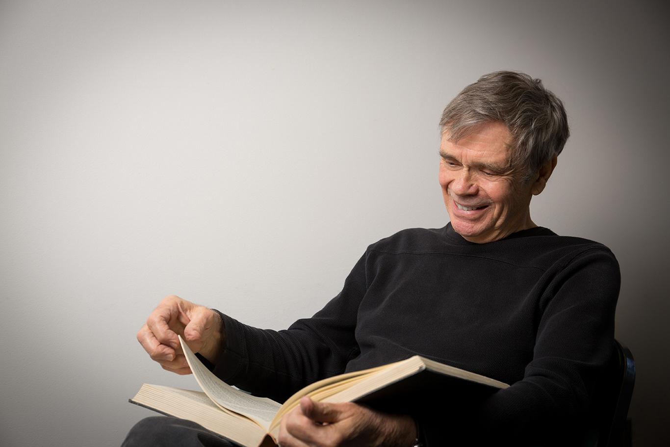Photo of Professor Sid homan reading a book.