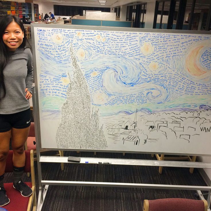 Van Truong standing next to her starry night artwork on a library whiteboard
