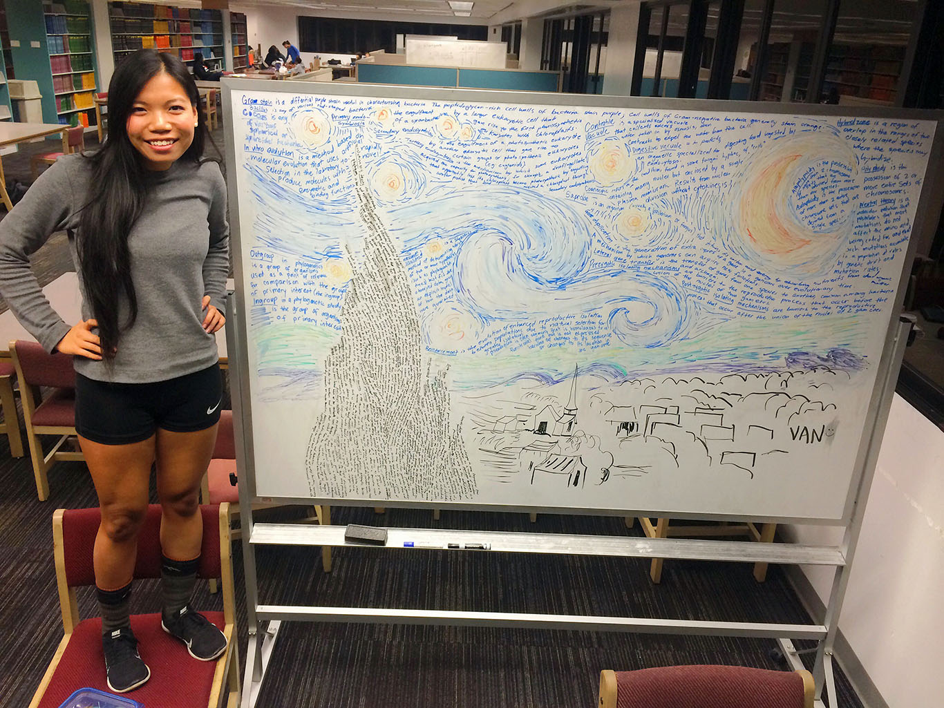Van Truong standing next to her starry night artwork on a library whiteboard