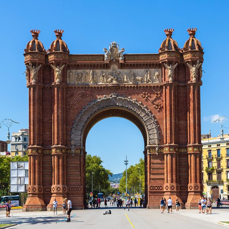 Spanish archway with blue sky and plaza beyond