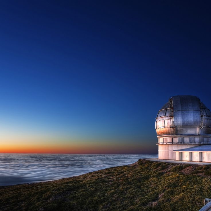 photo of telescope overlooking ocean