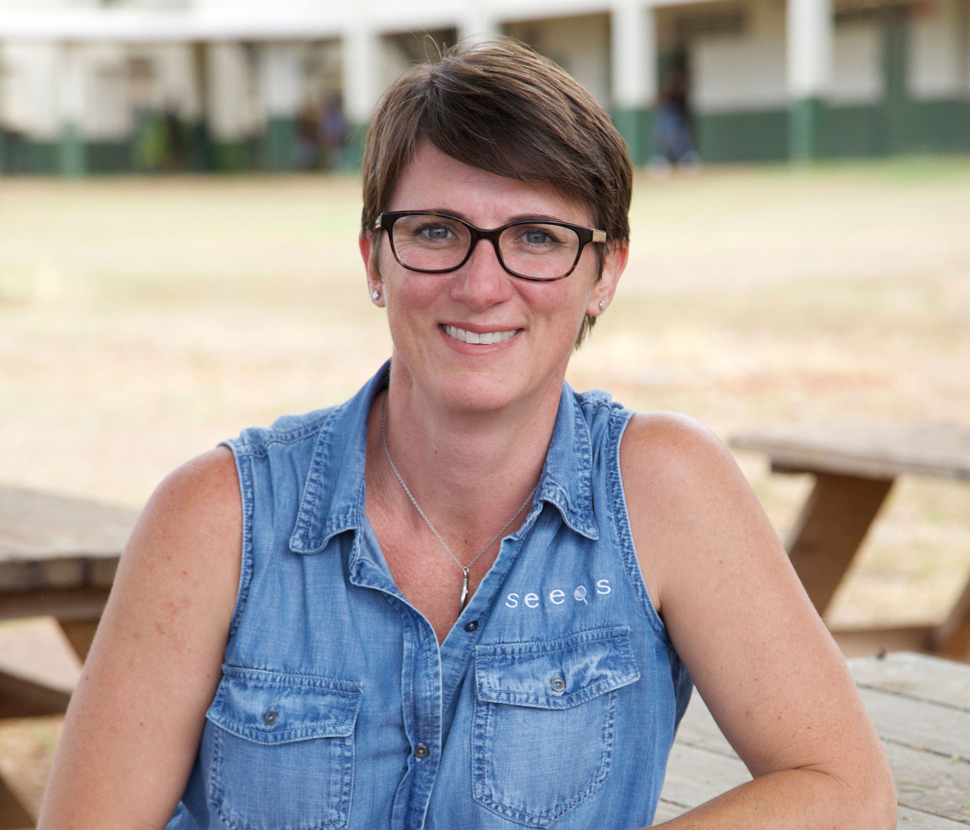 friendly woman leans on picnic table