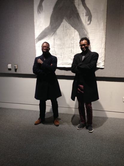 two men standing in art gallery