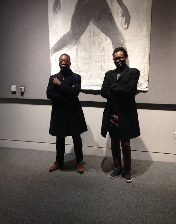 two men standing in art gallery