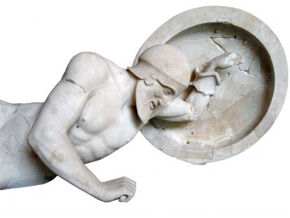 photograph of sculpture of fallen Grecian soldier holding shield