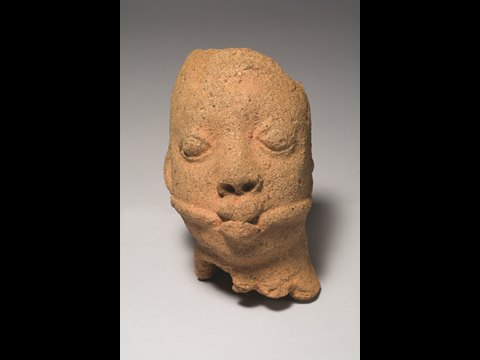 Figure 7: Gagged head. Ọ̀sángangan Ọbámákin, Ifẹ̀. Twelfth – fifteenth century c. e. Terracotta; Height: 5 1/4ins (13.5 cm). Reproduced by permission of the National Commission for Museums and Monuments, Nigeria, 49.1.20; and courtesy of the Museum for African Arts, New York, USA