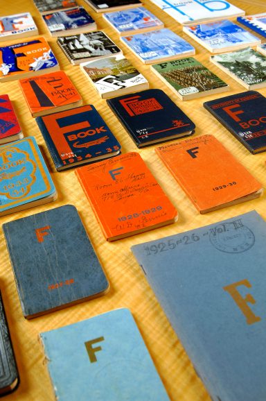 colorful small books spread out over table