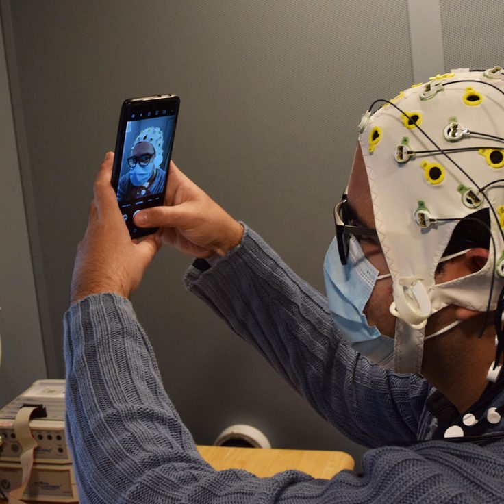 Reinaldo Cabrera Pérez takes a selfie while wearing an electroencephalography (EEG) cap.