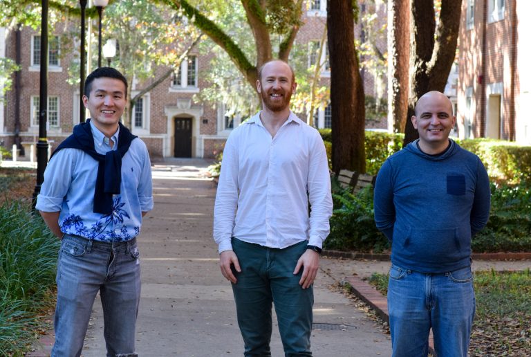 Liwei Chang, Alberto Perez and Ramon A. Miranda Quintana pose for a group portrait on campus