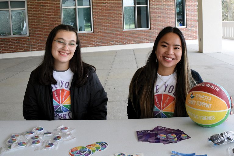 Mailys Angibaud and Delaney Phelps promote mental wellness at a tabling event in front of the Reitz Union on campus. 