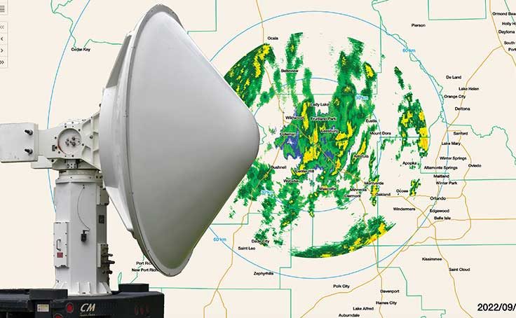 A data set of storms captured by the mobile radar unit shows bands of rain, wind and lightning. Overlay of RaXPol's large and imposing rotating pedestal.