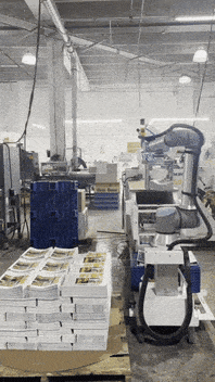 A giant robot art moves printed magazines in a printing warehouse