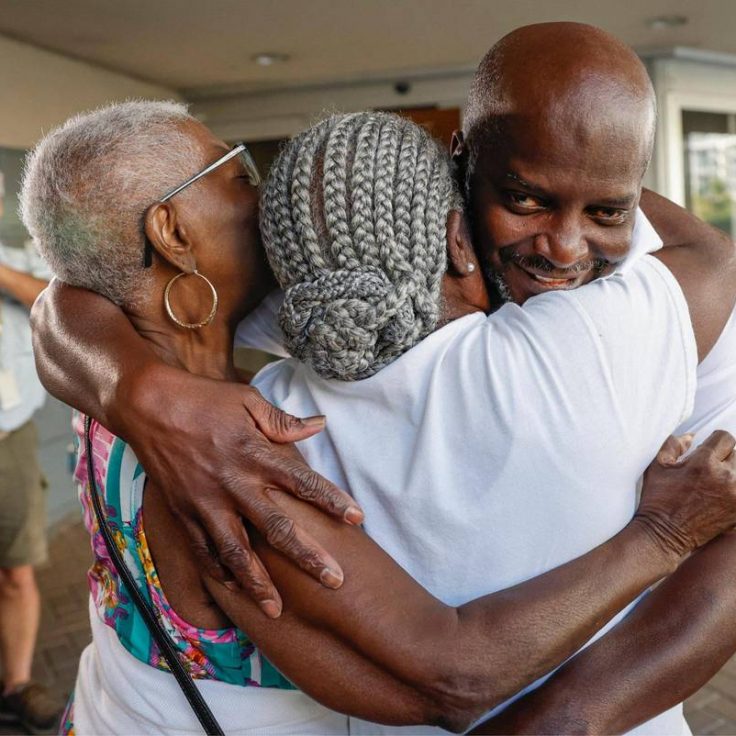 Man hugs his family in celebration after his release from 34 years in prison after being exonerated.