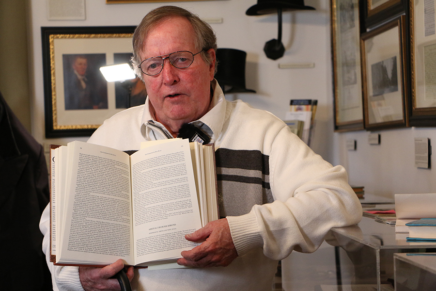 Bob Seeley holds a book during his interview.