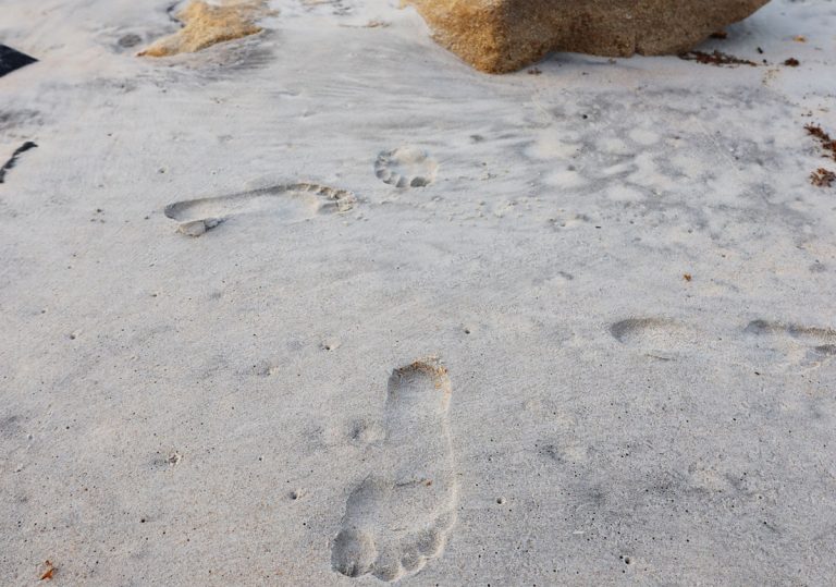 human footprint makes mark in sand