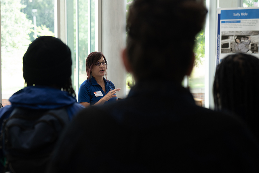 woman speaks to a group of students