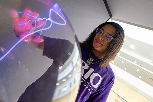 A student with a plasma globe