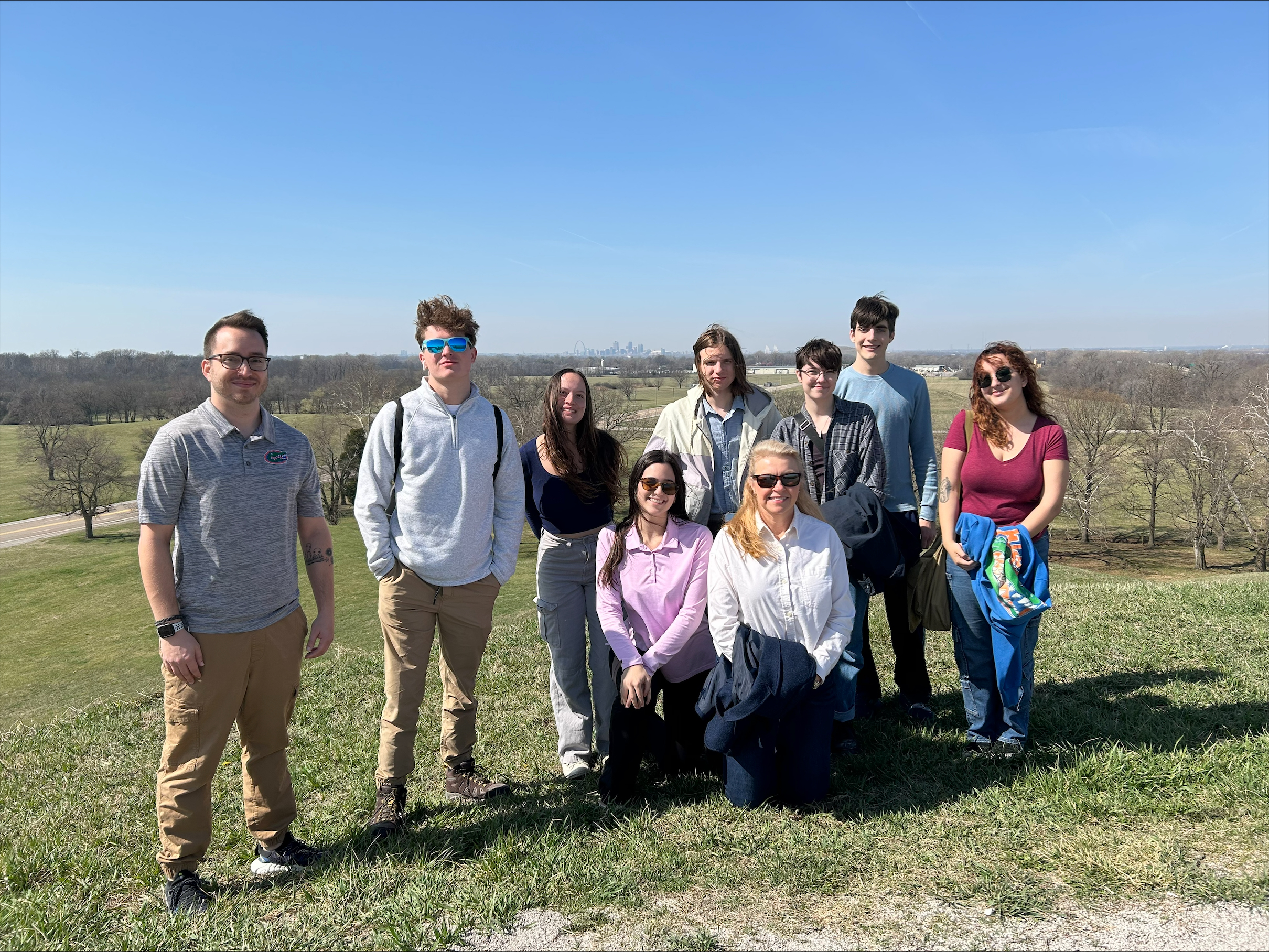 students stand near archeological site