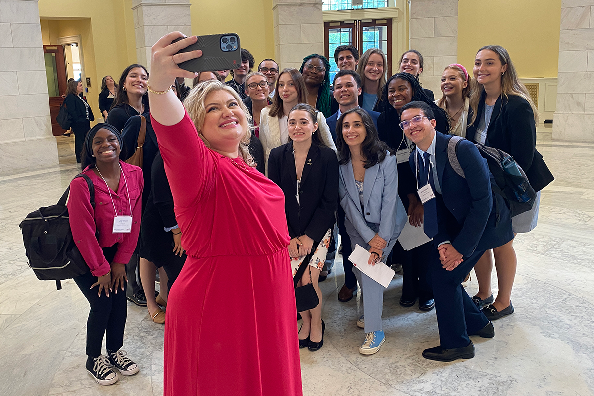 Kat Cammack poses for a group photo with Beyond120 students, including Eduardo Linardi.