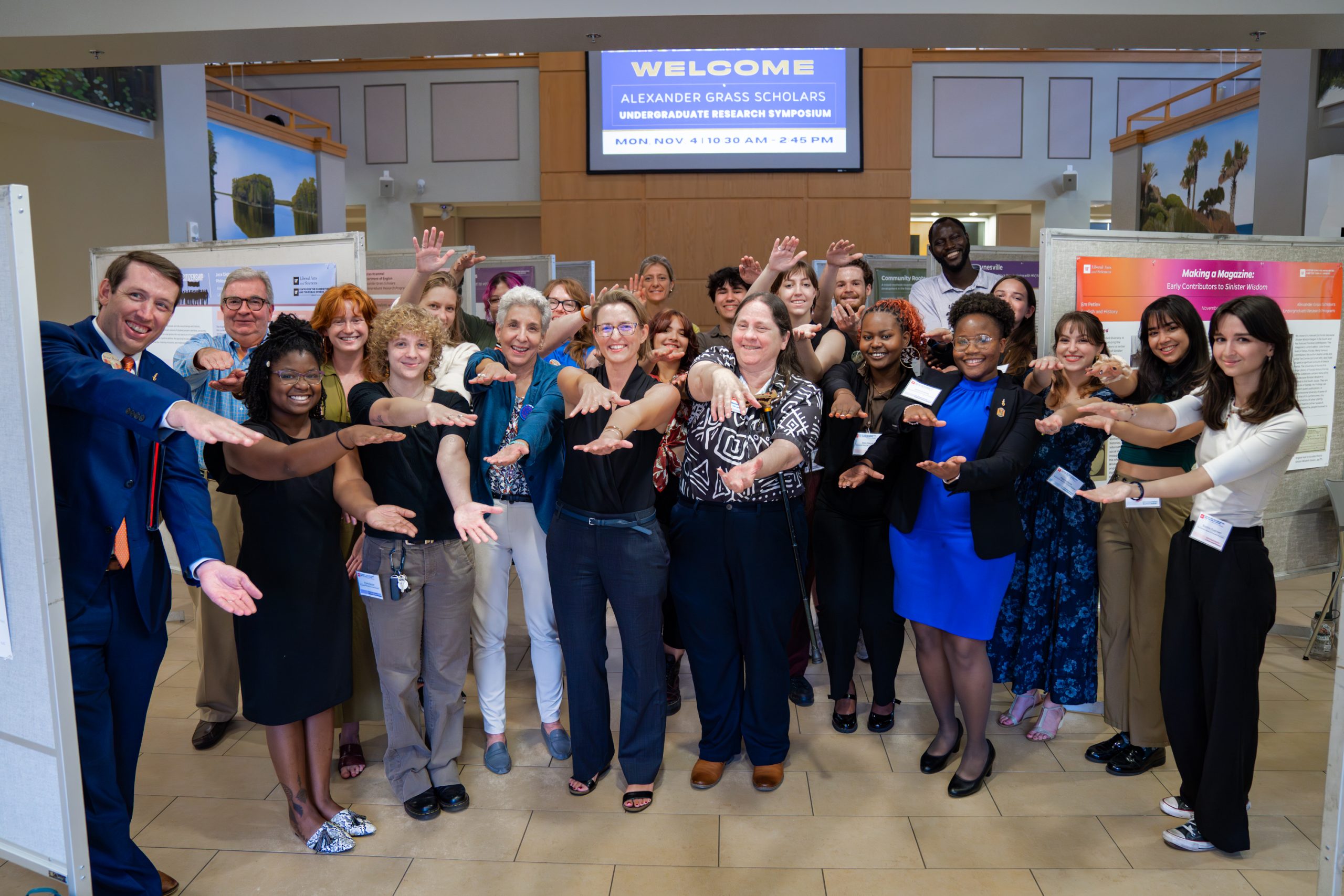 Group photo of students and CHPS faculty doing the gator chomp.