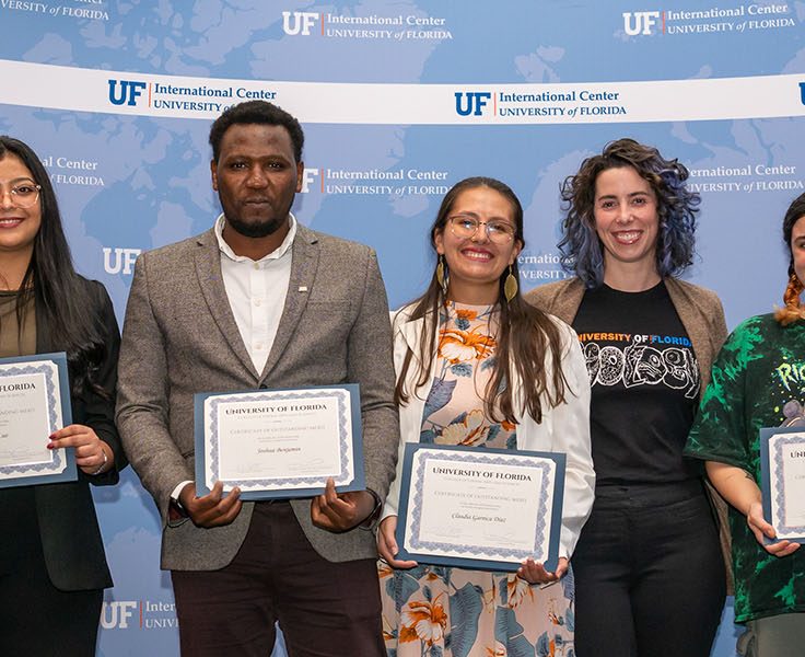 Row of people holding certificates.