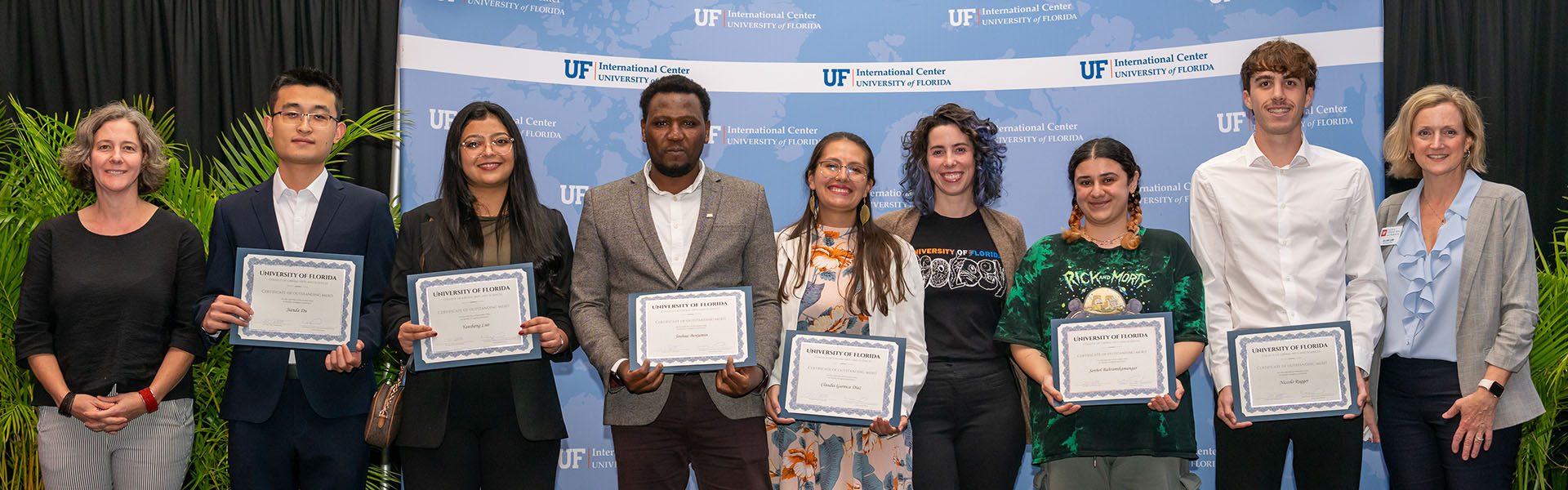 Row of people holding certificates.