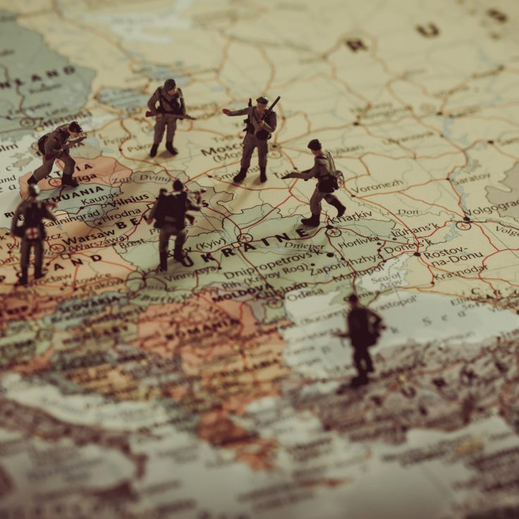 Miniature models of soldiers are posed on top of a map of Ukraine and Western Russia.