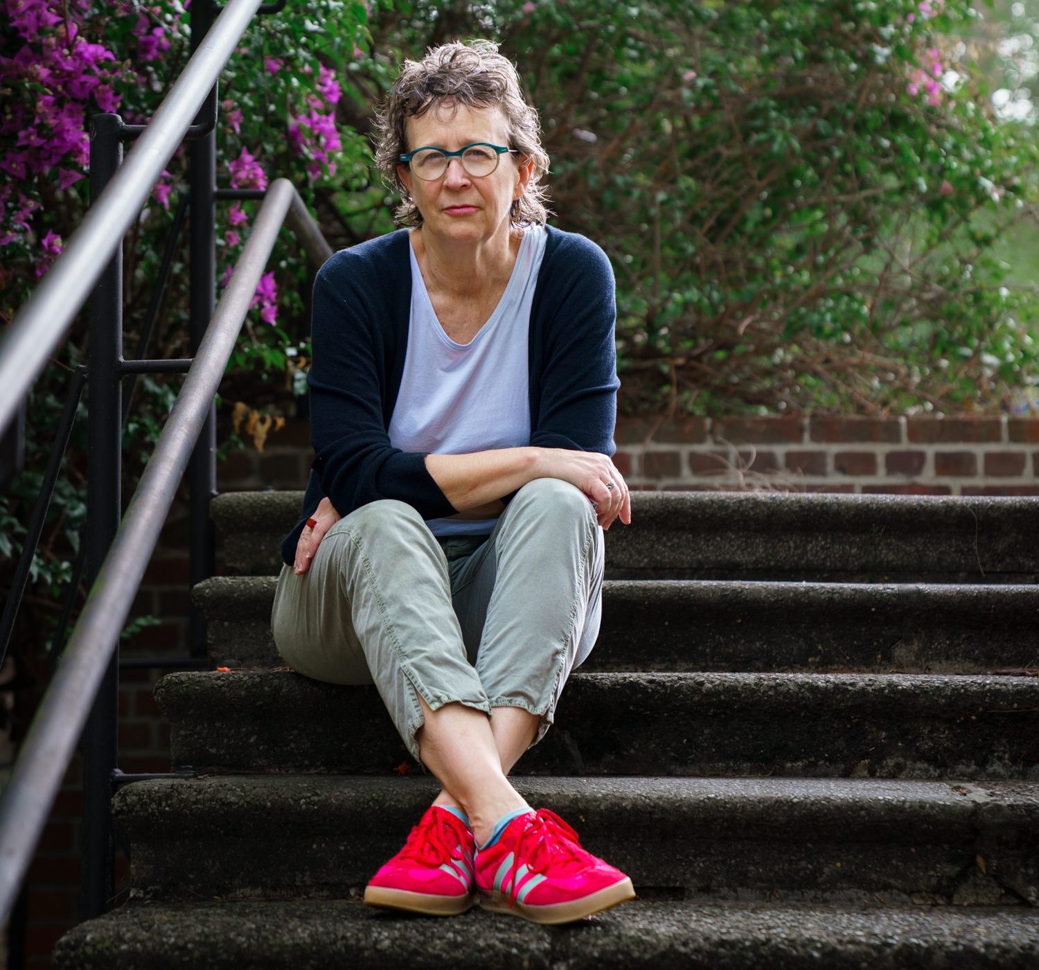 Woman sitting on steps, outside.