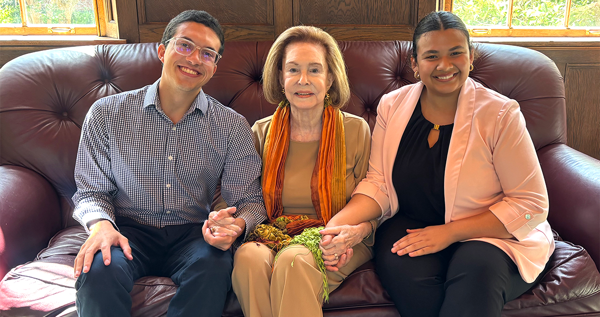 Three people sitting on couch.